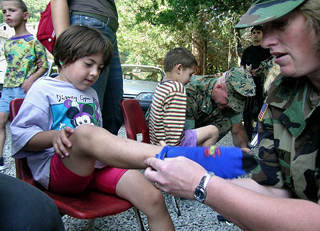 A photograph of a young girl recieving a new pair of shoes and socks. A photograph of a young girl recieving a new pair of shoes and socks.