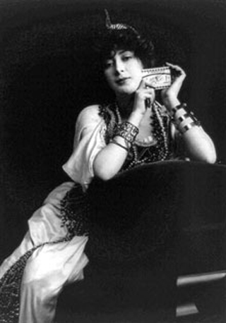 A woman from the early 20th century hodling up a pack of cigarettes A woman from the early 20th century hodling up a pack of cigarettes