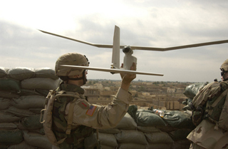 A photograph of an U.S. Army soldier launching a Raven unmanned aerial vehicle. A photograph of an U.S. Army soldier launching a Raven unmanned aerial vehicle.