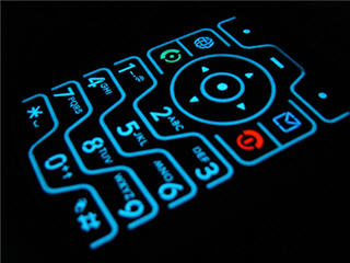 A cell phone keypad illuminated in the dark.