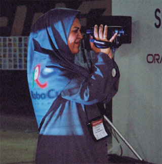 Photo of Iranian woman engineer using a video camera.
