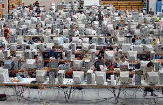 A photograph of a venue where multiple computers have been set up and networked. A photograph of a venue where multiple computers have been set up and networked.
