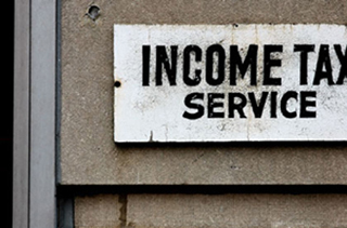 Photograph of a sign advertising income tax preparation.