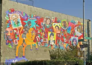 A colorful mural on the side of a building portrays 90 female activists throughout history. 